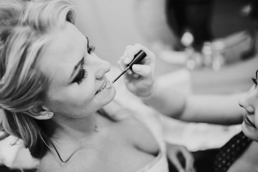 Bridal lip detail being applied in soft studio light
