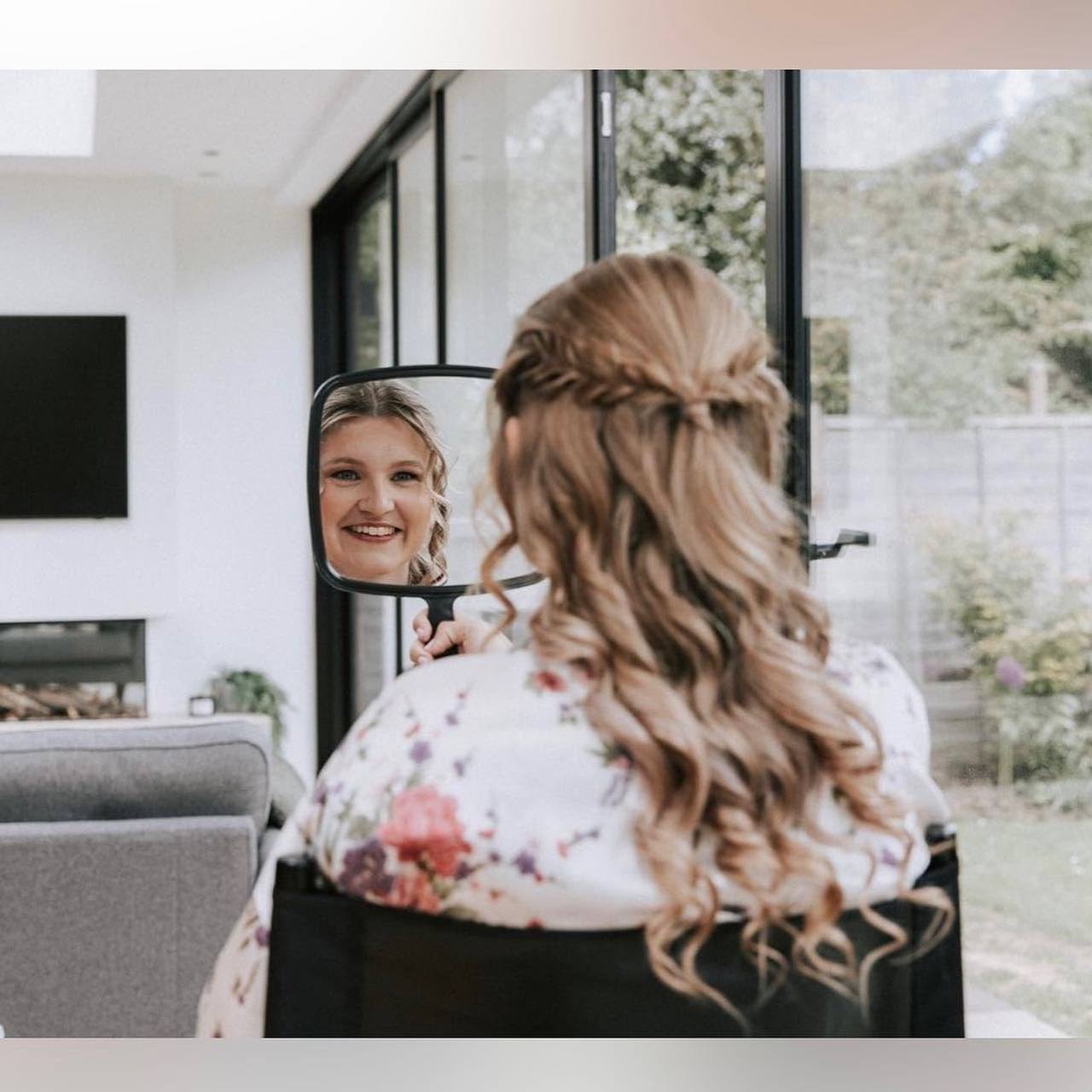 Bride seeing her finished bridal makeup in the mirror